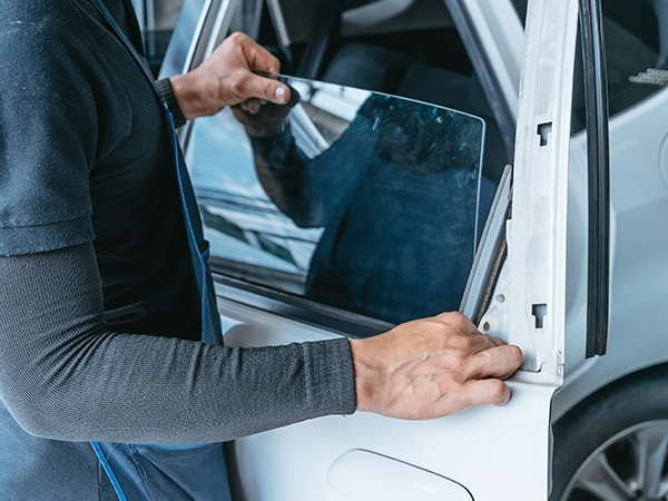 Operatore di Technoglass, attiva a Varese e Novara, sostituisce il finestrino laterale di un’auto.