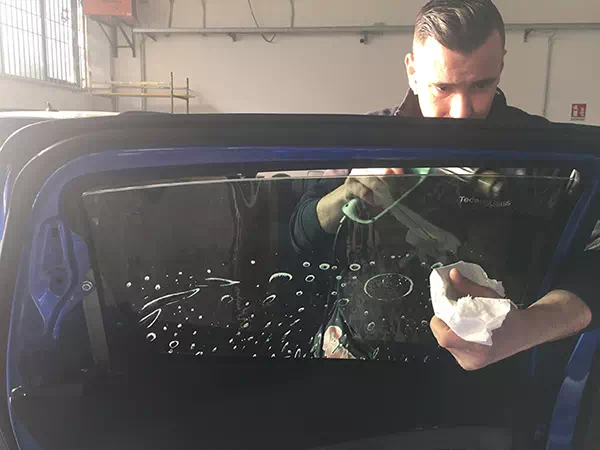 Operatore di Technoglass, centro attivo a Varese e Novara, effettua trattamento antipioggia.